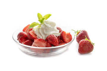 Fresh strawberries, whipped cream and peppermint garnish in a glass bowl, isolated with shadows on a white background, copy space