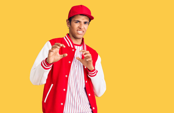 Young african amercian man wearing baseball uniform disgusted expression, displeased and fearful doing disgust face because aversion reaction. with hands raised
