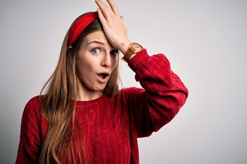 Young beautiful redhead woman wearing red casual sweater and diadem over yellow background...