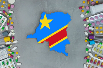 The Democratic Congo State began research for treatment and medicine to combat the pandemic outbreak disease coronavirus. Medicine, pills, needles, syringes and Congo map and flag on gray background.