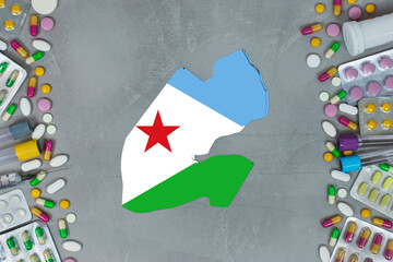 The Djibouti State began research for treatment and medicine to combat the pandemic outbreak disease coronavirus. Medicine, pills, needles, syringes and Djibouti map and flag on gray background.