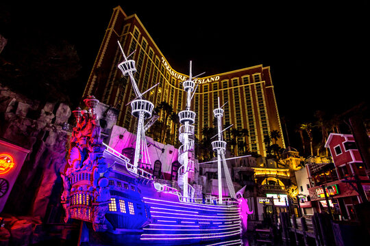 Las Vegas, Nevada, USA - February 20, 2020: Illuminated exterior of the Treasure Island Hotel and Casino completed with pirate ship on the Las Vegas Strip.