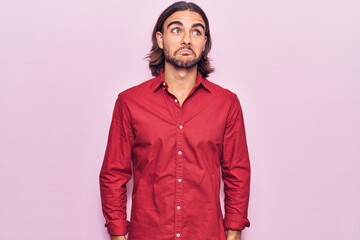 Young handsome man wearing business clothes smiling looking to the side and staring away thinking.