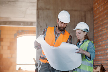 A factory worker and an engineer make an inspection. Factory worker and business woman on the...