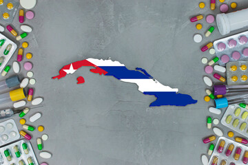 The CubaState began research for treatment and medicine to combat the pandemic outbreak disease coronavirus. Medicine, pills, needles, syringes and Cuba map and flag on gray background.