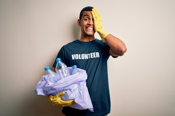 Handsome african american volunteer man recycling plastic bottles caring the envirnment stressed...