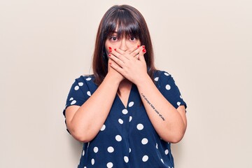 Young plus size woman wearing casual clothes shocked covering mouth with hands for mistake. secret...