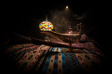 Lamp of wishes concept. Antique Aladdin arabian nights genie style oil lamp with soft light white...