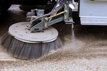 Street sweeper machine cleaning the streets in utility service of the town.