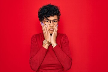 Fototapeta na wymiar Young beautiful african american afro woman wearing turtleneck sweater and glasses Tired hands covering face, depression and sadness, upset and irritated for problem