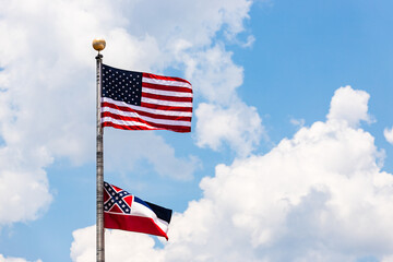 State of Mississippi flag and United States flag waving in the wind