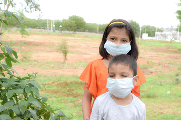 INDIAN BROTHER AND SISTER WITH WEARING  MASK DURING COVID 19 