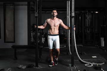 caucasian athletics man posing in gym and fitness club