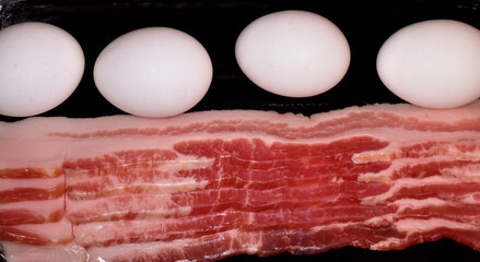 Bacon and eggs ready for the skillet.