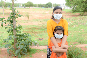 a mother and her daughter with wearing mask for protection of corona virus during covid 19 pandemic