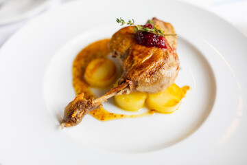 roasted duck leg with potato and orange sauce