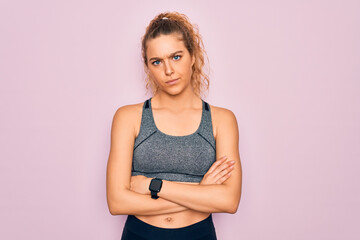 Young beautiful blonde sportswoman with blue eyes doing exercise wearing sportswear skeptic and nervous, disapproving expression on face with crossed arms. Negative person.