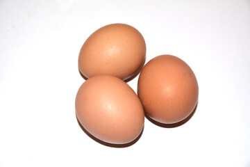 Three brown chicken eggs lie on an abelone background. Idea for breakfast. Ingredients for cooking