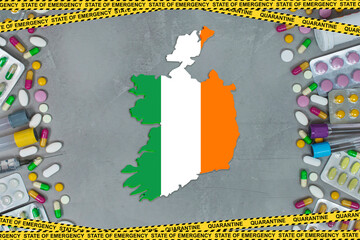 Ireland is struggling with an epidemic coronavirus pandemic. Ireland quarantine measures and coronavirus. Medicine, drugs, needles, syringes and Ireland map and flag over gray background.