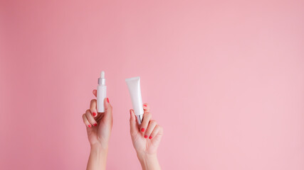 hand hold cosmetic skincare on pink background.beauty banner. - obrazy, fototapety, plakaty