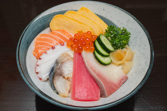 Chirashi donburi (salmon, tuna, tamago egg, hamachi, shime saba, tako) in Japanese restaurant.