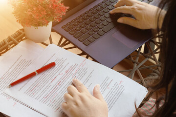 working hands on blurred paperwork and laptop