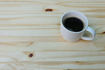 Coffee of the day, americano coffee cup free space on wooden background , top view.