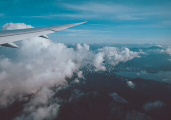 Fototapeta na wymiar Sunrise above clouds from window of an aircraft
