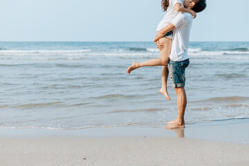 Romantic couple having love and hug on the beach.