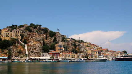 Fototapeta na wymiar Symi town, Symi island, pictorial view of colorful houses and Yialos harbour
