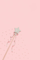 Festive decoration, bright silver star with sequins on soft pink background with white beads. Minimal holiday concept. Flat lay.