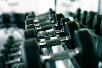 Obraz na płótnie Canvas dumbbell set. Close up dumbbells on rack in sport fitness.
