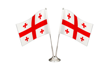 Georgia table flag isolated on white ground. Two flag poles with flags and Georgia flag on the table.
