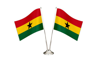 Ghana table flag isolated on white ground. Two flag poles with flags and Ghana flag on the table.