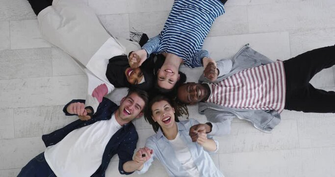 Group of happy young students showing unity