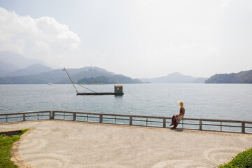 woman sit near the water