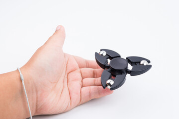 Nonthaburi, Thailand - June, 16, 2017 : Women hand holding popular fidget spinner toy.