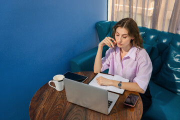 Girl working at the sofa with her Laptop