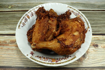 Deep fried crunchy chicken in Thai style with flour and flavor on the plate. Famous street food menu in Asia. Popular appetizer menu in party. 