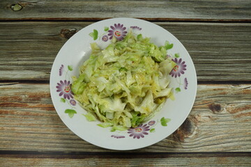 Fried cutting cabbage with oily and pepper. Famous vegetarian food in Asia. Side dish salad menu in Chinese restaurant. High fiber and nutrition food. 