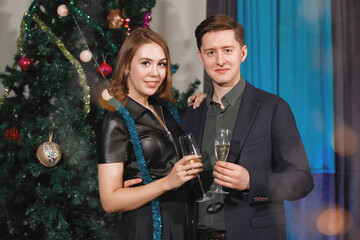 Couple near Christmas tree.