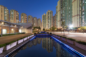 High rise residential building and public park in Hong Kong city at dusk