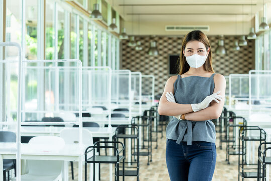 Wman Restaurant Owner Wear Mask And Glove Reopen The Restaurant After Closed From City Lock Down Decorated With Plastic Screen For Customer Seperation For Covid Protection Policy