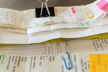Credit card slips and invoices to claim business expenses on an expense report