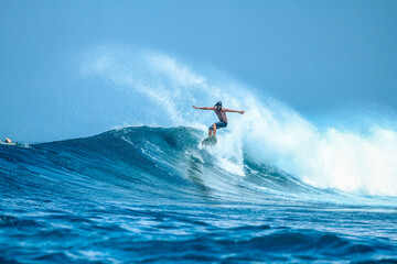 Surfer on perfect blue aquamarine wave, empty line up, perfect for surfing, clean water, Indian Ocean .