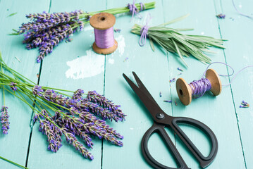 lavender bouquet arrangement with modern scissors on blue wooden