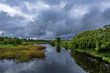 River Uvod with green banks in the city of Ivanovo on a cloudy  day.