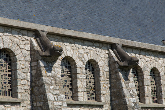 Dolphins sculptures on Chapelle Notre-Dame-de-la-Garde on a cliff in Etretat, Normandy, France