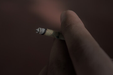 hand holding a cigarette