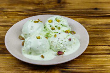 Pistachio ice cream on wooden table